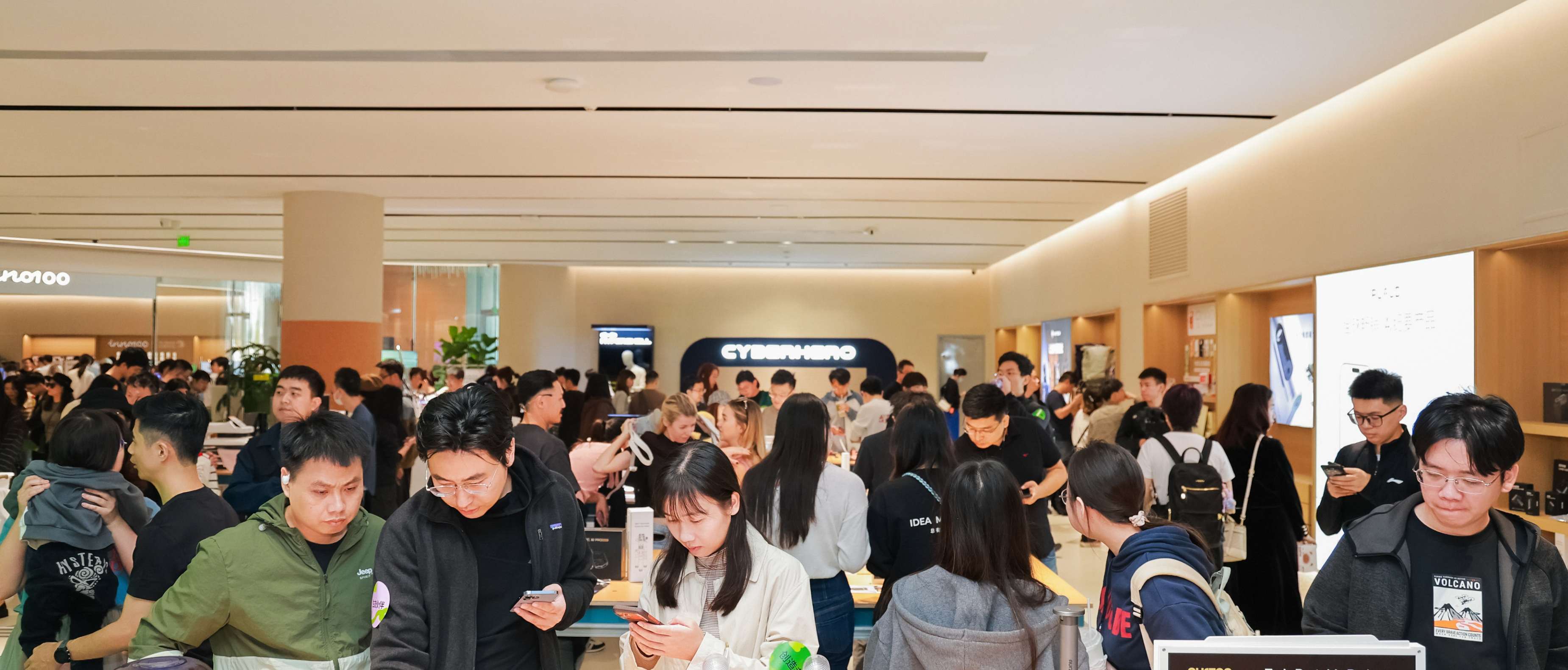 Visitors exploring and interacting with innovative consumer technology products inside the INNO100 retail flagship store