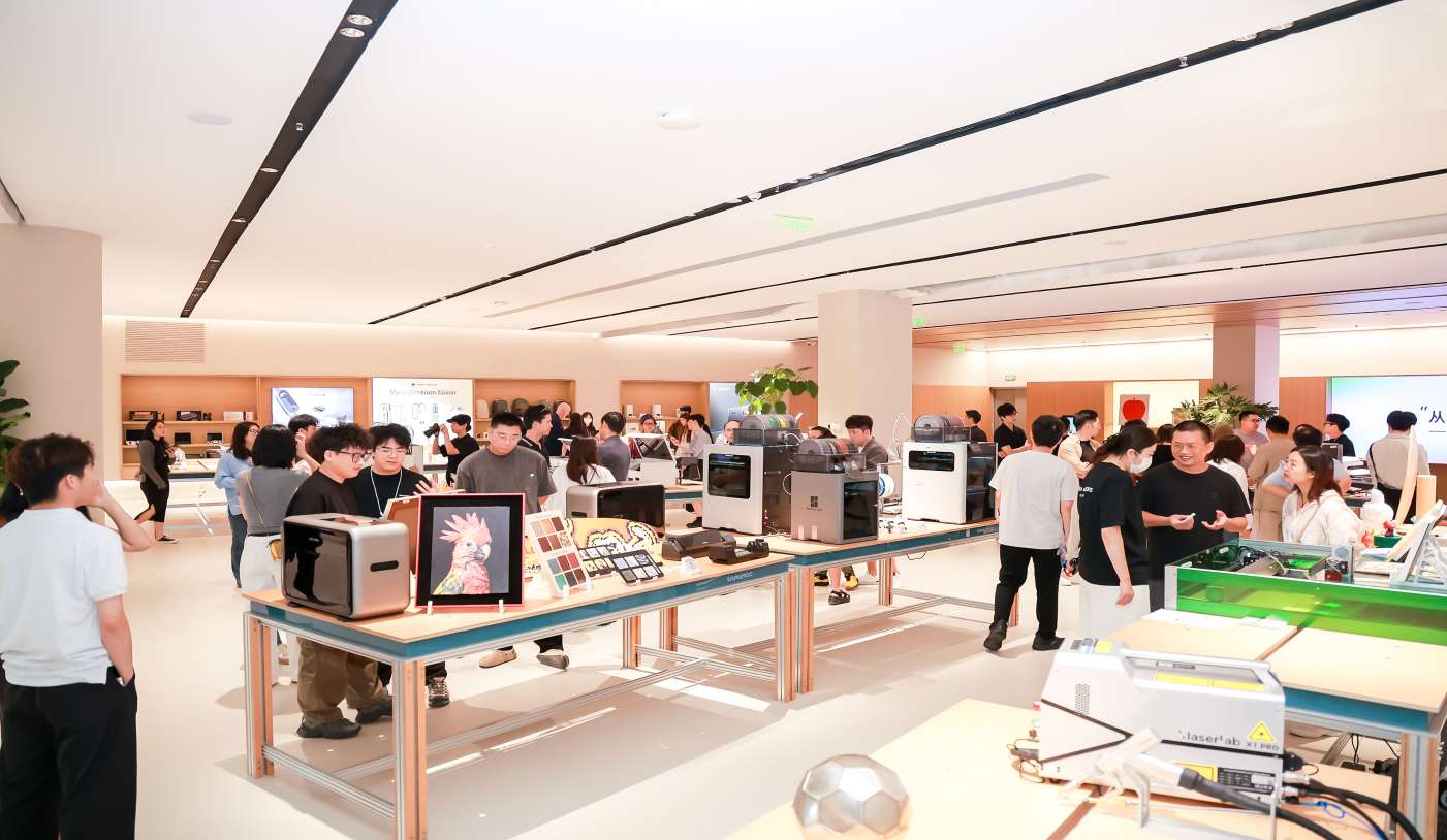 Visitors explore and interact with various consumer technology products displayed on tables inside the INNO100 flagship retail store