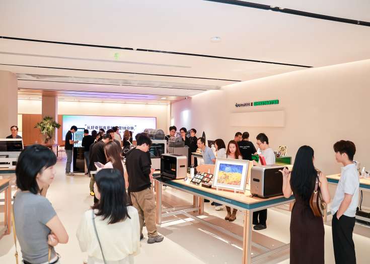 Visitors exploring and interacting with innovative consumer technology products displayed on tables inside the INNO100 flagship retail store